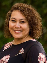 A women looks at the camera in a corporate pose