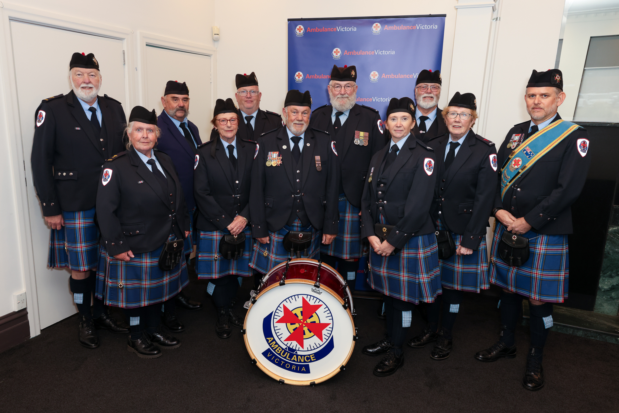 Members of the AV Pipes and Drums pose in uniform
