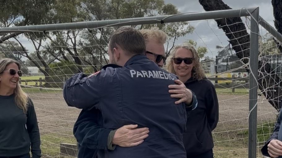 A man hugging a paramedic.